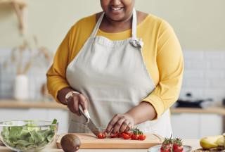 A woman chopping produce.